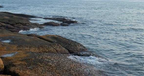 Sea and sunset with wave rock stone