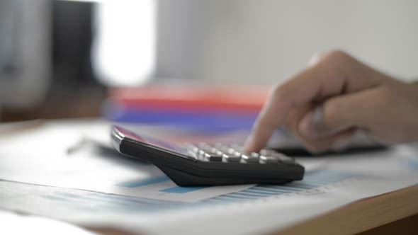 Businessman Calculating in Office