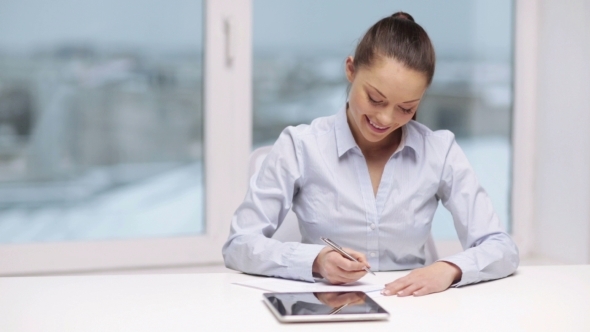 Business Woman With Tablet Pc And Papers In Office