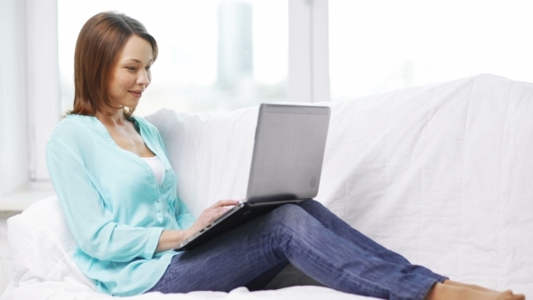Smiling Woman With Laptop Computer At Home