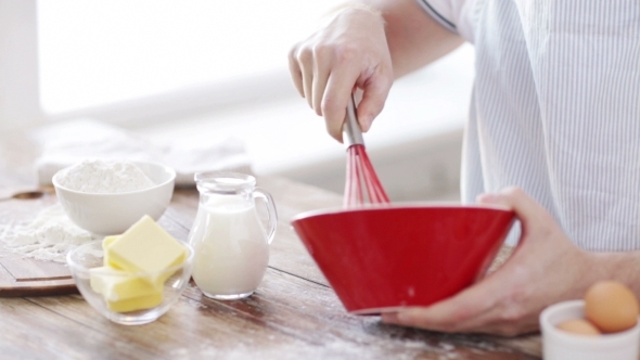 Male Hand Whisking Dough In Bowl