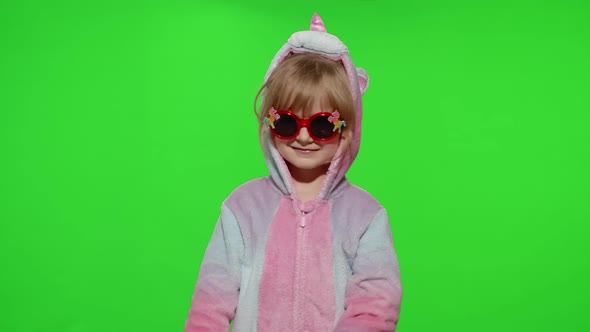 Little Child Girl Smiling Dancing Making Gun Gesture with Hands in Unicorn Pajamas on Chroma Key