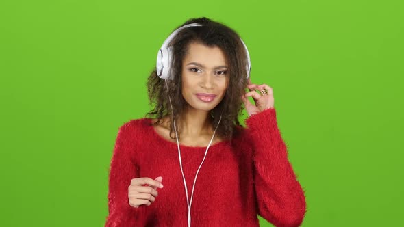 Afro American Girl Dancing with Headphones on Green Screen, Close-up