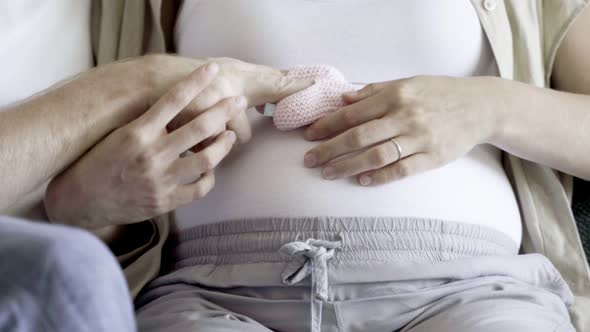 Closeup Shot of Couple Sitting and Playing with Booties