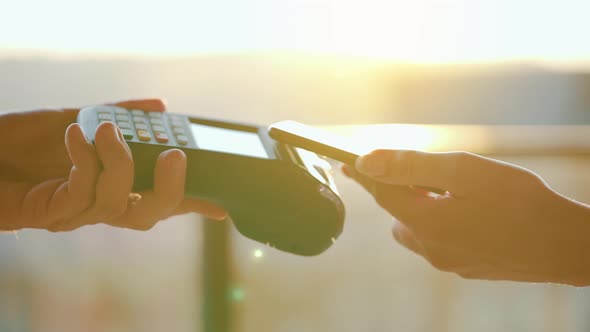 Closeup Woman Using Smartphone Cashless Wallet NFC Technology to Pay Order on Bank Terminal