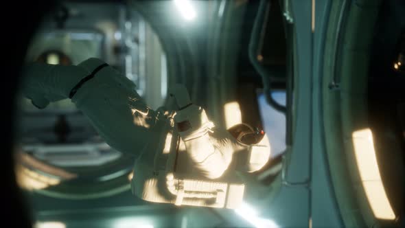 Astronaut Inside the Orbital Space Station alt
