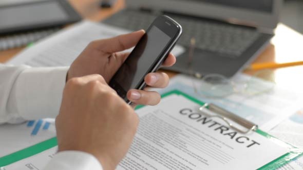 Businessman Using Smartphone at Work