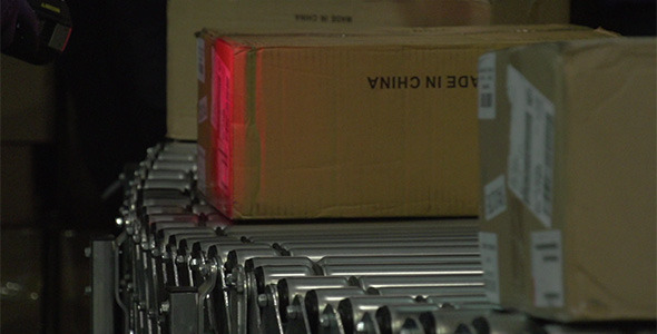 Boxes on Conveyor Belt Being Scanned in Warehouse