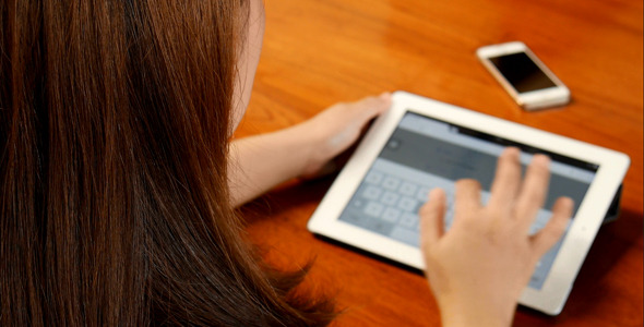 Woman Using Touch Screen Tablet