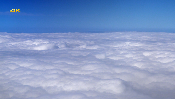 Flying Over Clouds from Airplane Window