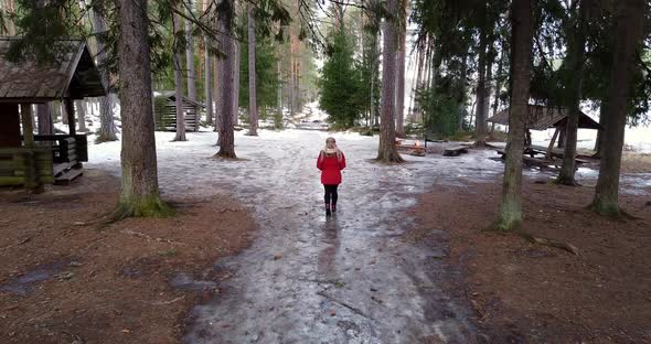 A Woman Walking Through Forest to the Campsite
