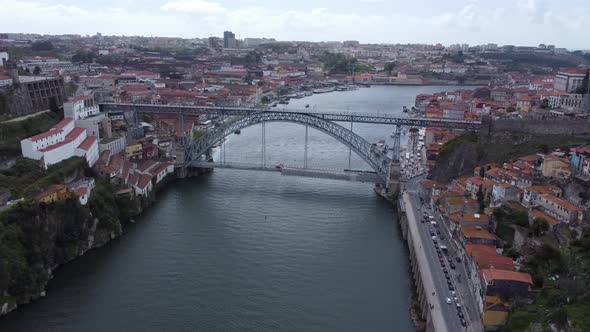 Drone reveal shot of Dom Luís I Bridge –  double-deck metal arch bridge over the River Douro between