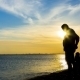Silhouette Of Man With a Child On Sea Background - VideoHive Item for Sale