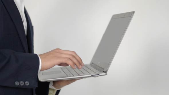 Businessman Using Laptop in Hands