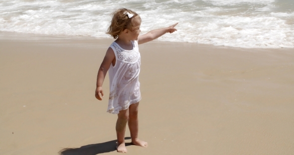 Cute Little Girl Pointing Out To Sea alt