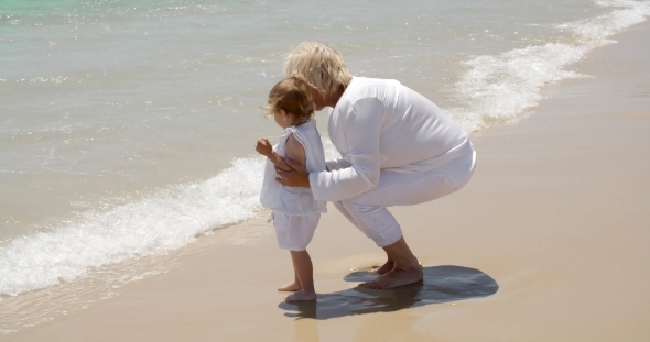 Grandma And Little Girl Having Fun At The Beach