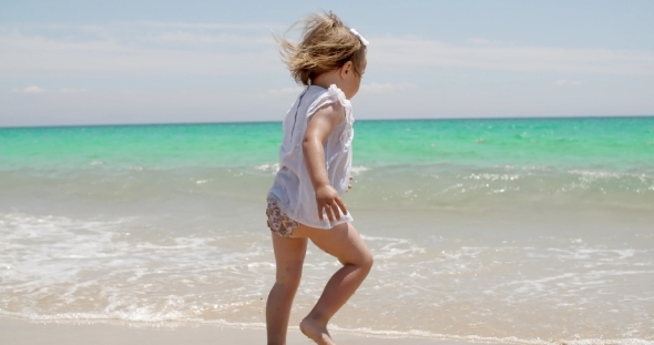 Little Girl Romping At The Edge Of The Surf
