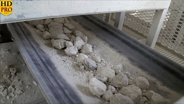 Rolling of Rocks on a Conveyor