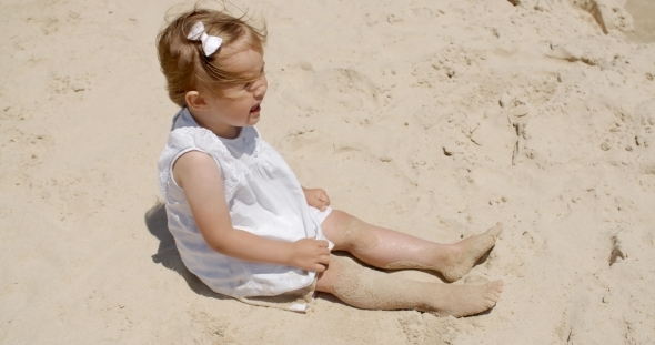 Laughing Little Girl Having Fun On The Beach