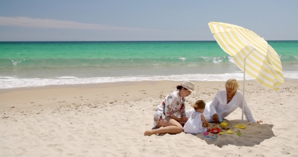 Grandma  Mom And Little Girl Playing At Beach Sand