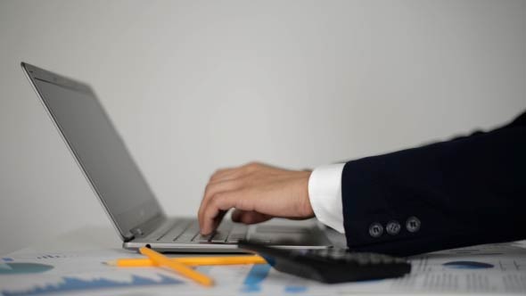 Businessman Typing on Laptop 