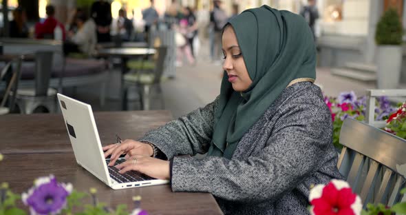 Woman in Hijab Work with Laptop in Cafe