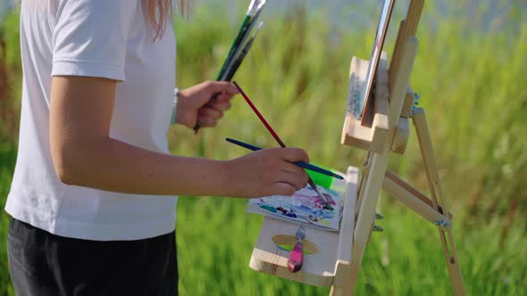 Artist Blending Oils When Painting Before Nature