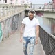 slow motion young beautiful bearded man outdoor listening music walking down the street - VideoHive Item for Sale