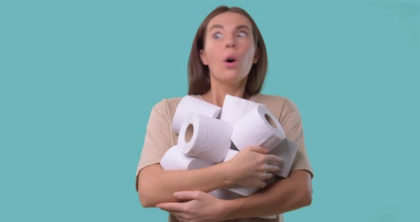 Woman Holds Rolls of Toilet Paper