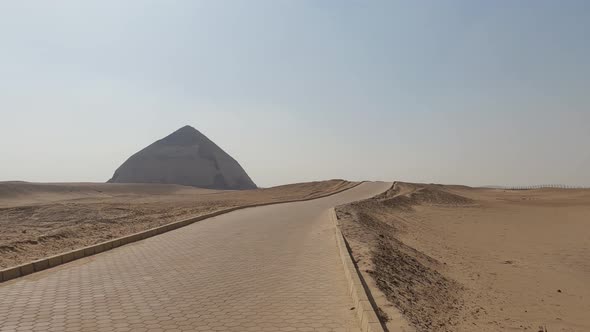 Sandy Yellow Desert With Ancient Egyptian Bent Pyramid On The Horizon, Egypt