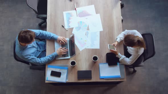 Team Sitting at the Desk with Documents