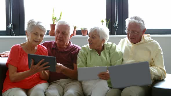 Senior citizens using digital tablet, mobile phone and laptop