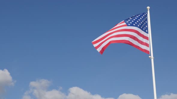 Recognizable United States of America flag fabric flying on the wind and flag pole 4K 2160p 30fps UH