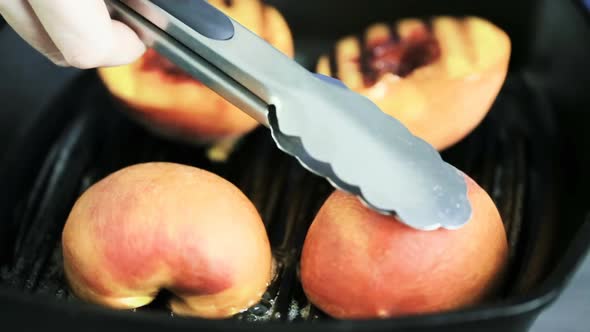 Time lapse. Grilling organic peaches in cast iron skillet.