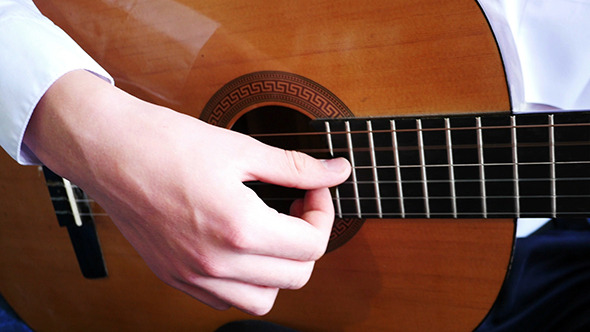 Young Man Playing A Guitar Solo