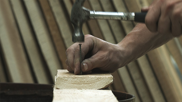 Hammering Nails Into Wood