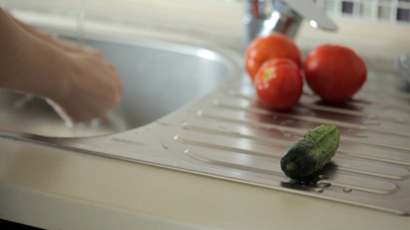 Washing Tomatoes In The Sink