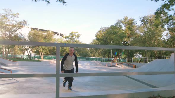 Young Man Doing Parkour Tricks in Extreme Sports Park