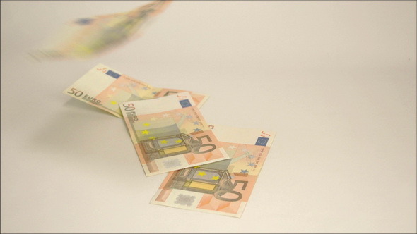 Seven 50 Euro Bills Dropping on the Table