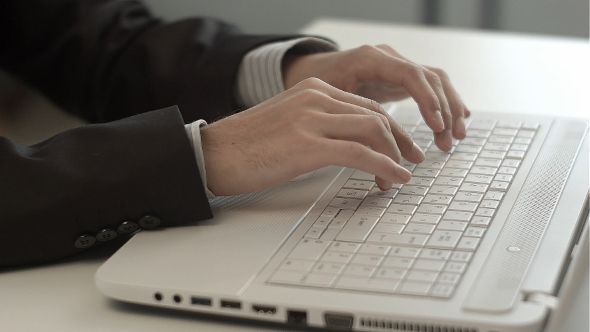 Man's Hands Typing On Keyboard Notebook alt