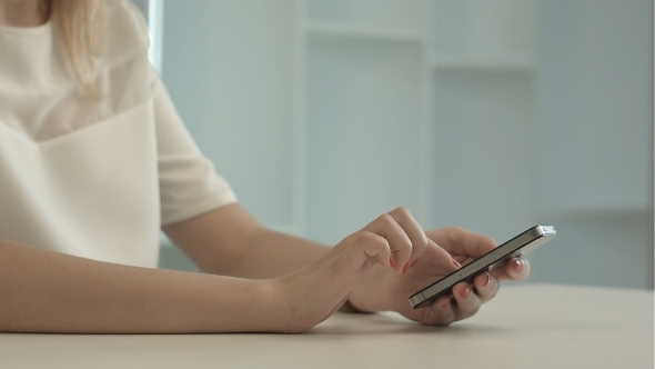 Young Woman Writing Sms Message On Mobile Phone alt