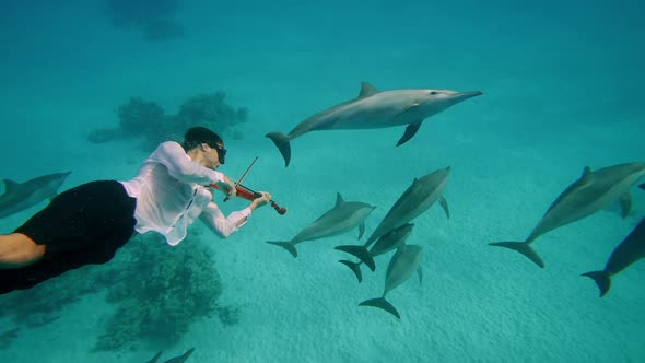 Young Man Figure in Underwater Sunrays Playing Violin Boy Relaxing and Swimming Bow Along Strings