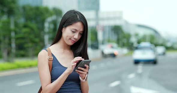 Woman use of mobile phone in city