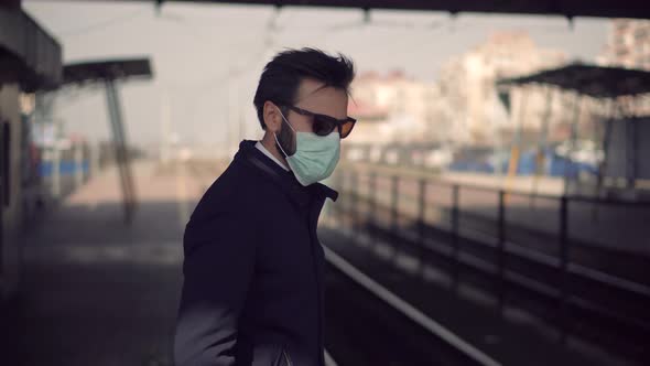 Man Waiting Tram Wearing Protective Mask COVID19 Virus. Pandemic Coronavirus Protection Outdoor.