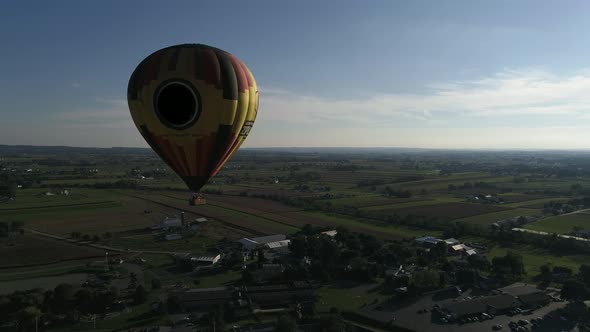 Hot Air Balloon Taking of and Flying for a Sunset Flight in Amish Countryside on an Autumn Day