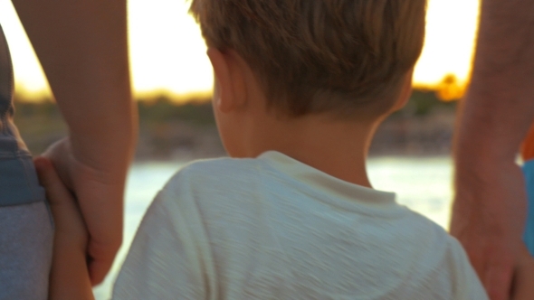 Boy Taking Parents' Hands alt