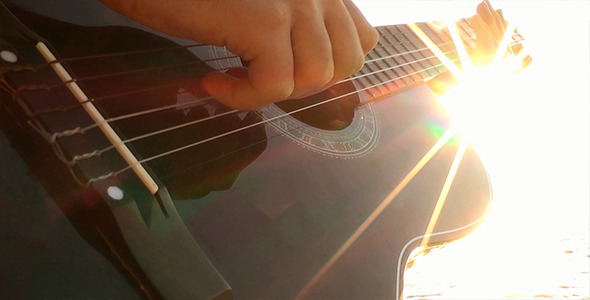 Playing Guitar at Sunset alt