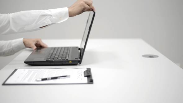 Businessman Opening Laptop and Typing 