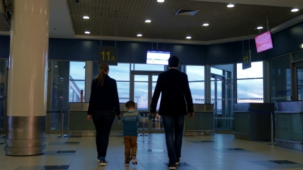 Parents And Son In Airport Terminal