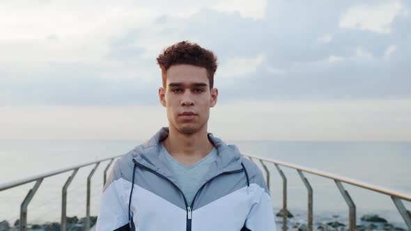 Young attractive athlete running and doing exercises on Bridge in the morning.